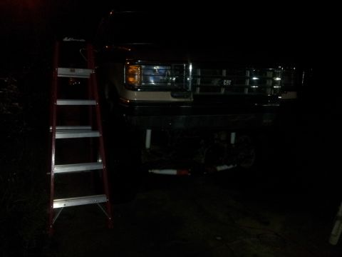 1988 Ford Bronco - Front view of a 1988 Ford Bronco with a ladder positioned to the side.