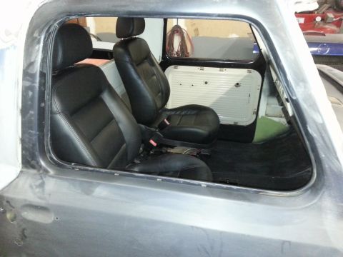 1967 Ford F-100 - The interior of a truck cab shows newly installed black bucket seats and door panels.