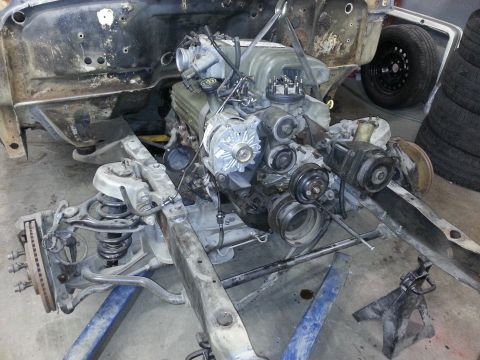 1967 Ford F-100 - The engine and front suspension of a vehicle are disassembled and supported by stands.