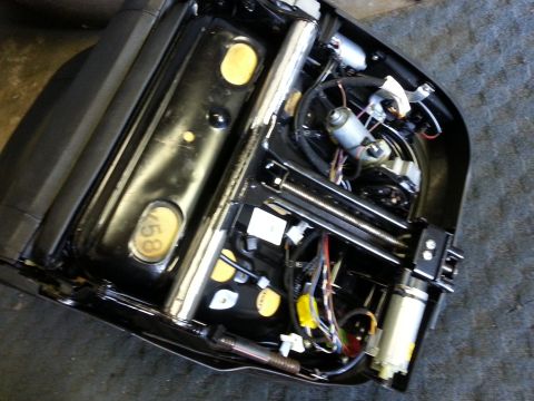 1967 Ford F-100 - Close-up view of a power seat mechanism, showing motors, gears, and electrical wiring.