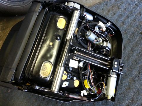 1967 Ford F-100 - Car seat mechanism with visible motors and wiring harness. Part number 458 is stamped on the seat base.