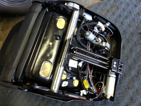 1967 Ford F-100 - The internal workings of a power seat mechanism are visible, showing motors and wiring.