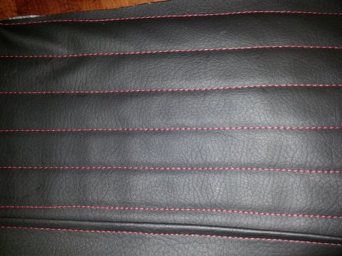 1967 Ford F-100 - The seat cover has a ribbed pattern created by red stitching on black vinyl.