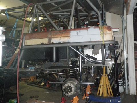 1961 International Scout 800 - The vehicle's frame and suspension components are exposed, indicating it is undergoing modifications or repairs.