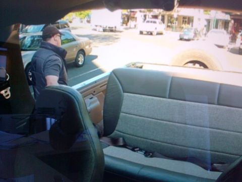 1994 Ford Bronco - View from inside a tan 1992 Ford Bronco, showing the rear seats and a spare tire.