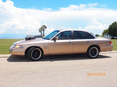 1993 Ford Crown Victoria - Modified 1993 Ford Crown Victoria with a prominent hood scoop and aftermarket wheels.