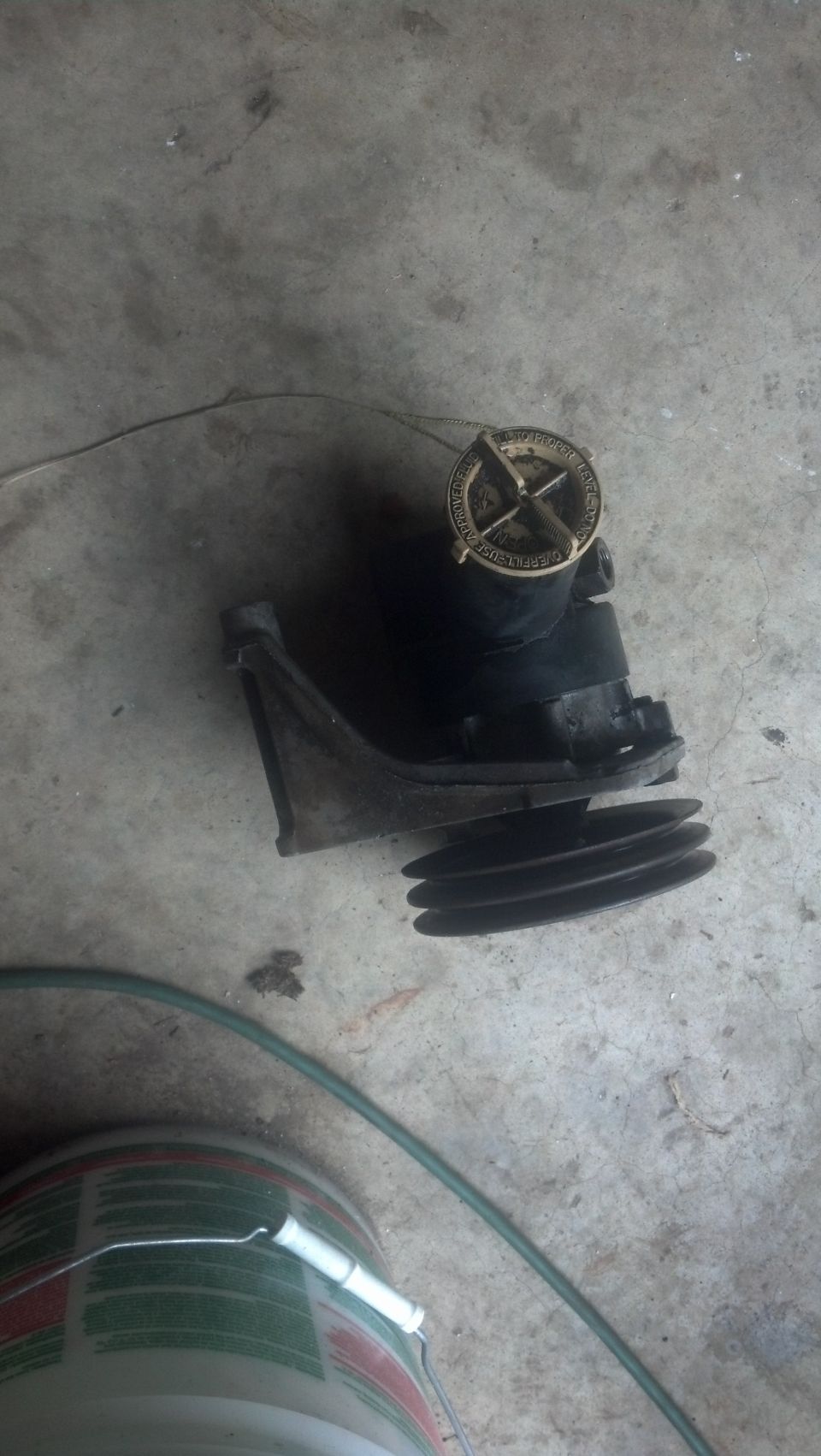 water pump pulley with a gold cap on top