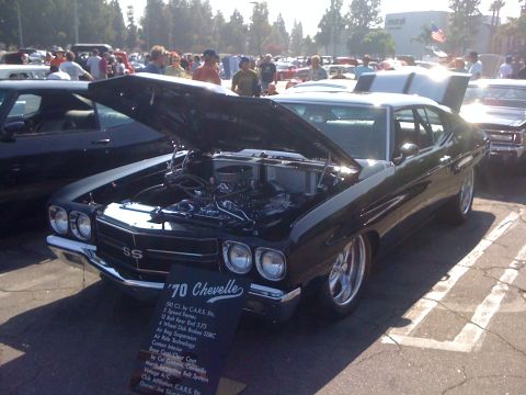 1964 Ford Ranchero - Black 1970 Chevrolet Chevelle SS displayed with hood open at an outdoor event.