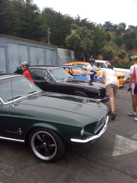 1964 Ford Ranchero - Several classic cars are parked in a line, with people standing around them.