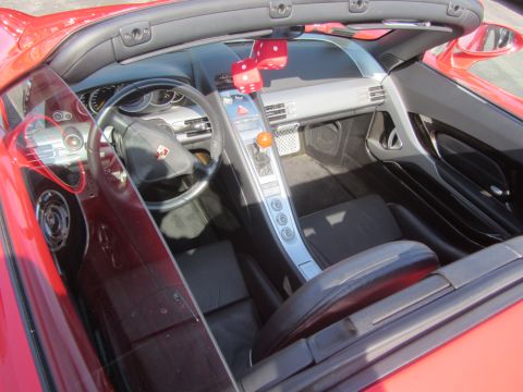 1964 Ford Ranchero - Interior view of a red convertible showing the dashboard, steering wheel, and seats.