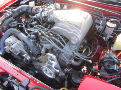 1964 Ford Ranchero - Close-up view of a V8 engine, showing the intake manifold, alternator, and serpentine belt system.