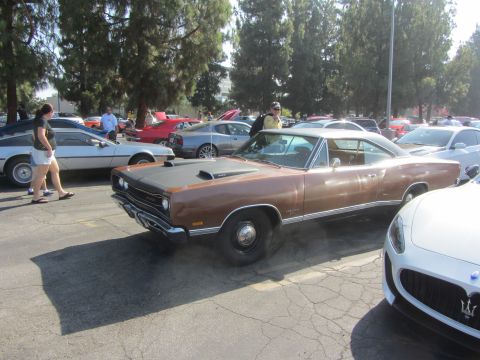 1964 Ford Ranchero - A brown 1969 Dodge Coronet is parked at an outdoor car show.