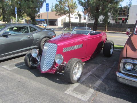 1964 Ford Ranchero - A custom hot rod, likely a 1934 Ford, is parked in a lot with other vehicles.