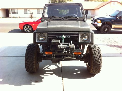 1987 Suzuki Samurai - This 1987 Suzuki Samurai features a prominent winch on its front bumper, ready for off-road adventures.