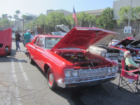 1964 Ford Ranchero - A red 1964 Plymouth Belvedere sedan is displayed with its hood open at an outdoor car show.