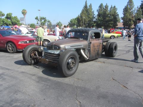 1964 Ford Ranchero - This custom hot rod truck features a unique build with exposed pipes and a rusty finish. Text on the door provides some history.