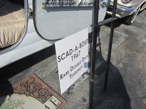 1964 Ford Ranchero - A sign reads 'SCAD-A-BOUT 1967 Rare Double Deck Teardrop' next to an open trailer door.
