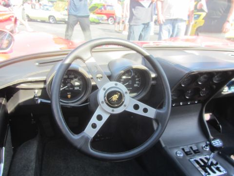 1964 Ford Ranchero - The interior of a Lamborghini Miura features a three-spoke steering wheel and multiple gauges on the dashboard.