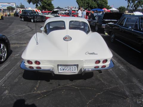 1964 Ford Ranchero - Rear view of a white 1963 Chevrolet Corvette Sting Ray with quad taillights and chrome bumper.