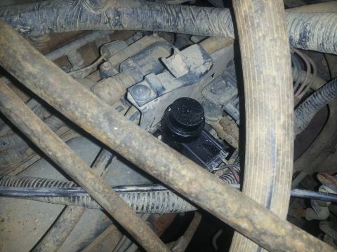 1988 Ford Bronco - Close-up view of engine bay components, including hoses and a black sensor, with visible wiring.