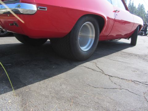 1964 Ford Ranchero - Rear view of a red 1969 Chevrolet Camaro with wide drag tires and polished alloy wheels.