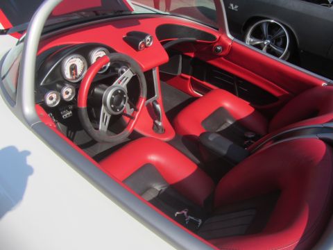 1964 Ford Ranchero - The custom interior features bright red seats and a dashboard with several gauges and a modern steering wheel.