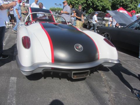 1964 Ford Ranchero - A custom sports car with a distinctive rear design is parked at an outdoor event.
