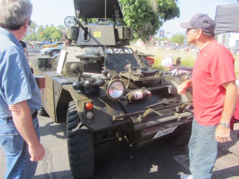 1964 Ford Ranchero - A military armored vehicle with license plate 00 CC 43 is displayed outdoors with onlookers.