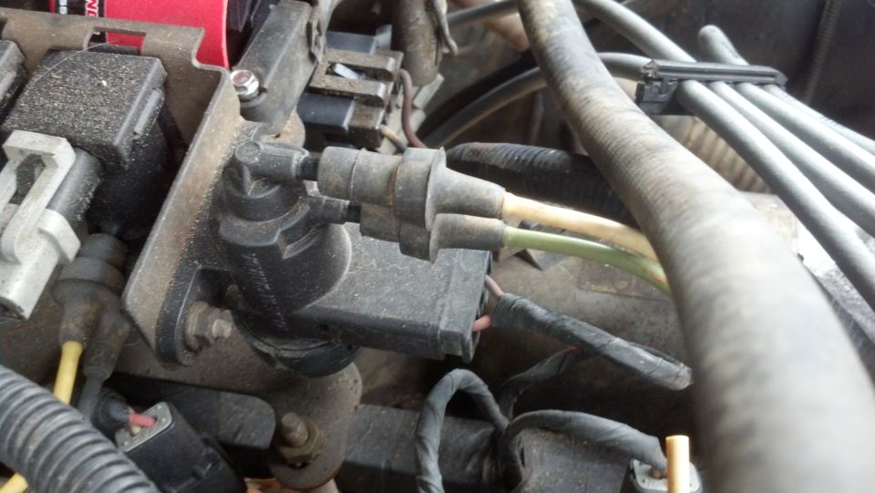 Engine wiring harness and vacuum lines connected to a black plastic component