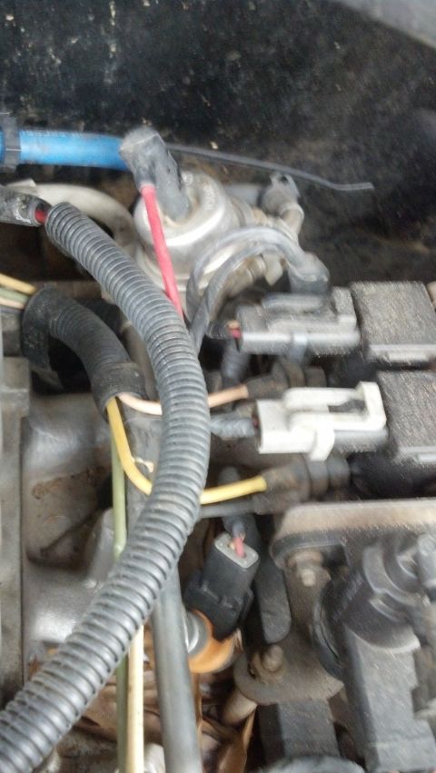 1993 Ford Bronco - Close-up view of engine bay components, including various wires and electrical connectors.