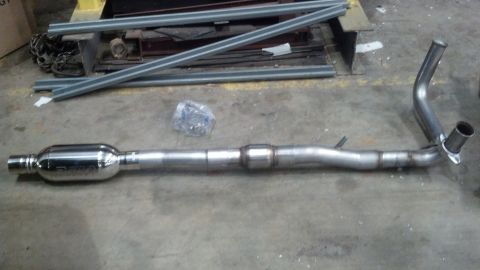 1993 Ford Bronco - Exhaust system part laid out on a concrete floor.