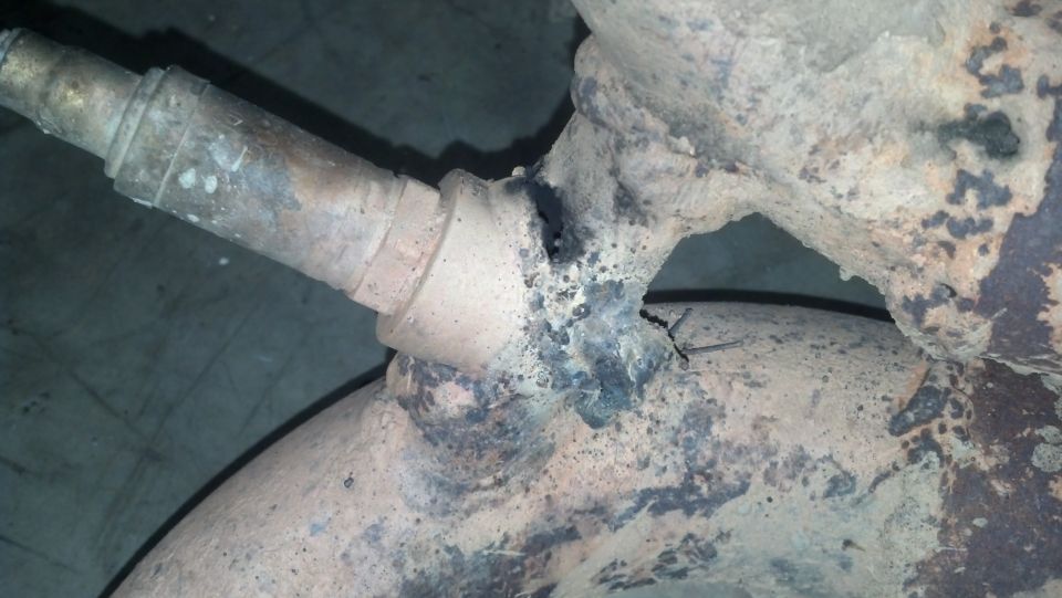 Exhaust pipe with a hole and visible weld damage