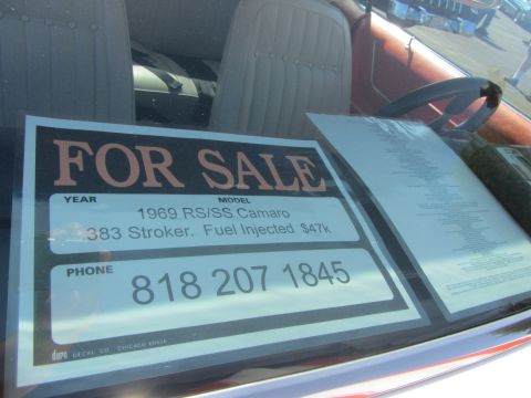 1964 Ford Ranchero - A 'For Sale' sign is displayed on the dashboard of a car, detailing a 1969 Camaro for sale.