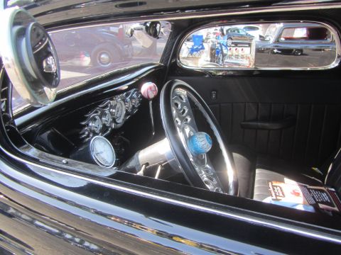 1964 Ford Ranchero - The interior of a custom hot rod features a chrome steering wheel and a dashboard with multiple gauges. A magazine rests on the passenger s…