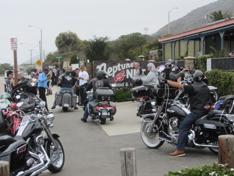 1964 Ford Ranchero - A group of motorcyclists are gathered outside Neptune's Net restaurant on a cloudy day.