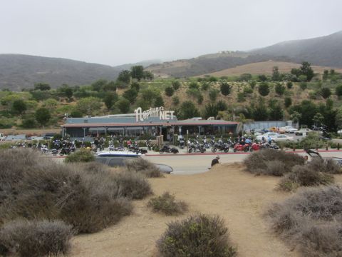 1964 Ford Ranchero - Motorcycles fill the parking lot of Neptune's Net restaurant on a cloudy day.
