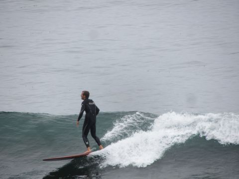1964 Ford Ranchero - A surfer catches a wave on a cloudy day.