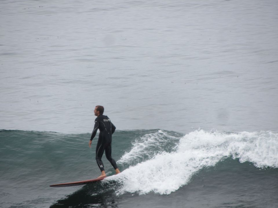 Surfer in a wetsuit riding a wave on a surfboard
