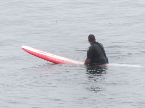 1964 Ford Ranchero - Surfer waits on a surfboard in the water.