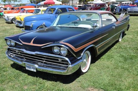 1991 Ford LTD Crown Victoria - A classic black 1959 Dodge Custom Royal with distinctive copper pinstriping is displayed at an outdoor car show.