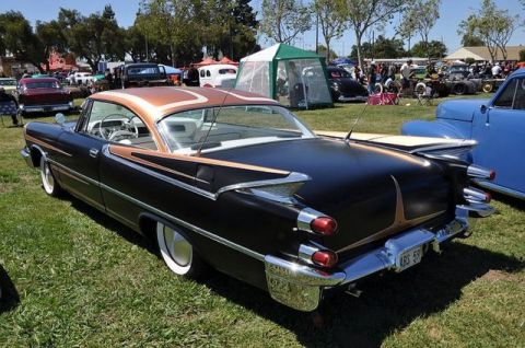 1991 Ford LTD Crown Victoria - This classic Dodge features a striking two-tone paint scheme and iconic tail fins, seen at an outdoor car show.