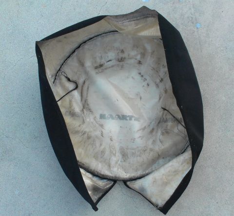 1994 Ford Bronco - Interior of a black seat cover showing a circular pattern and the word MAARTE.