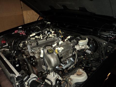 2004 Mercury Grand Marquis - The engine bay of a vehicle, showing the engine and associated wiring, with new exhaust headers installed.