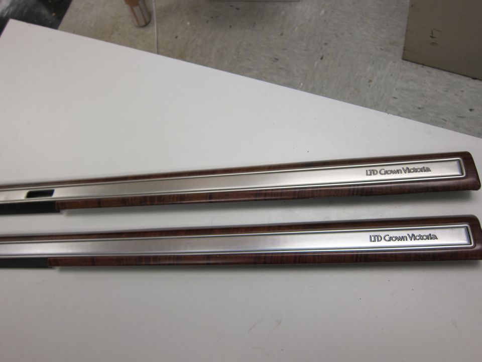 Two wood-grain interior trim pieces with chrome accents, each labeled LTD Crown Victoria