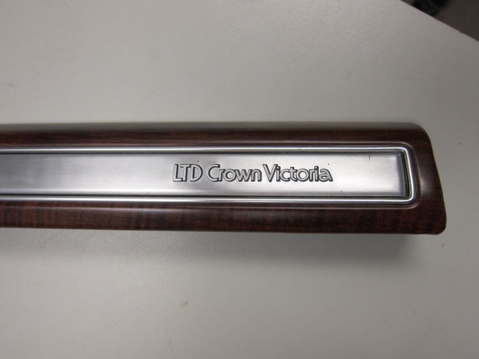LTD Crown Victoria trim piece with wood grain and chrome accent
