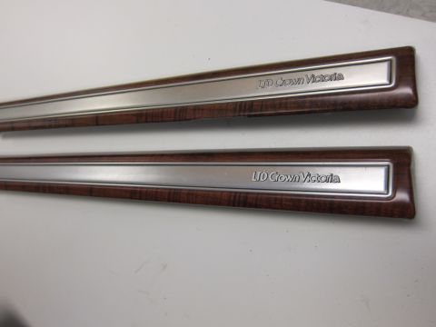 2001 Ford Crown Victoria - Close-up of two interior trim pieces labeled 'LTD Crown Victoria'.