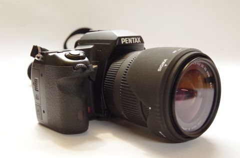 1983 Ferrari Enzo - A Pentax DSLR camera is shown with a Sigma lens, not a 1983 Ferrari Enzo.