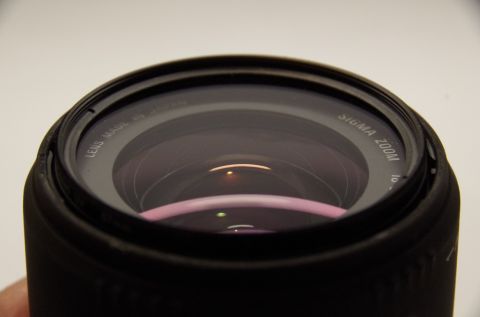 1983 Ferrari Enzo - Close-up of a Sigma Zoom camera lens, showing "LENS MADE IN JAPAN" text.