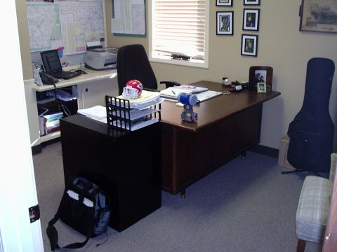 2000 Ford Taurus - This office space contains a desk, computer equipment, and a guitar case leaning against the wall.