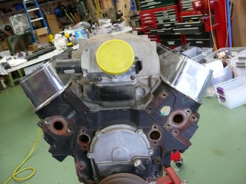 1976 Chevrolet Corvette - Engine block assembly with chrome valve covers and a yellow cap on the intake manifold.